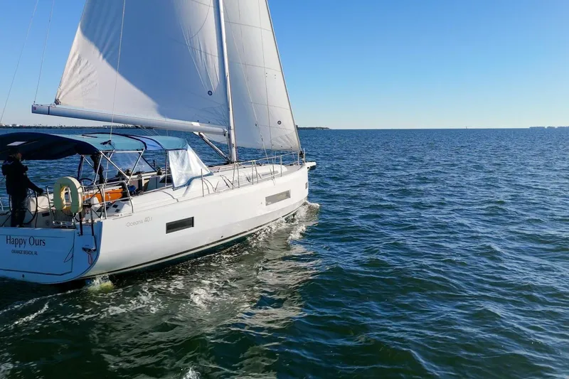 Slide: The Image of 2022 Beneteau Oceanis 40.1 sailing on open water under clear blue skies. - 132