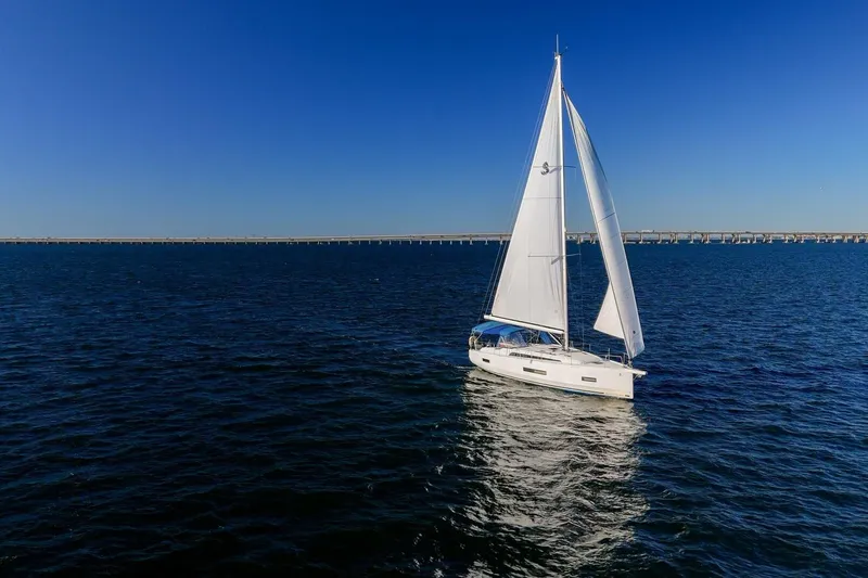 Slide: The Image of 2022 Beneteau Oceanis 40.1 sailing on open water under clear blue sky. - 154