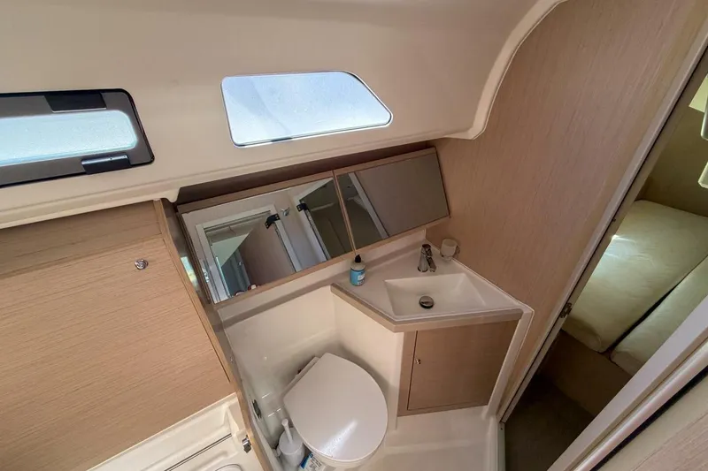 Slide: The Image of Interior of 2022 Beneteau Oceanis 40.1 yacht bathroom with sink, toilet, and mirror. - 17