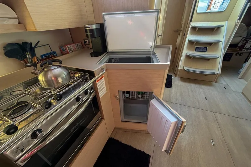 Slide: The Image of Modern kitchen in 2022 Beneteau Oceanis 40.1 yacht with stove, fridge, and storage. - 32