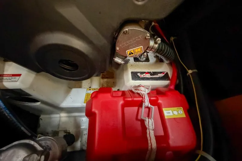 Slide: The Image of Engine compartment of 2022 Beneteau Oceanis 40.1 with red battery and mechanical components. - 41