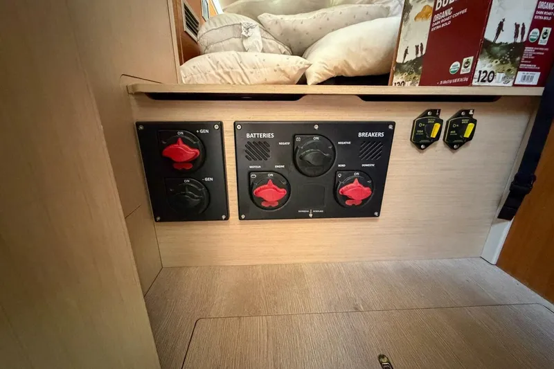 Slide: The Image of Electrical panel of 2022 Beneteau Oceanis 40.1 yacht, featuring battery and breaker controls. - 42