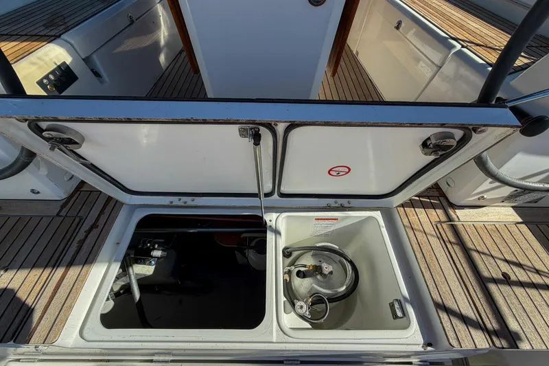 Slide: The Image of 2022 Beneteau Oceanis 40.1 yacht cockpit with dual steering wheels and wooden deck. - 51