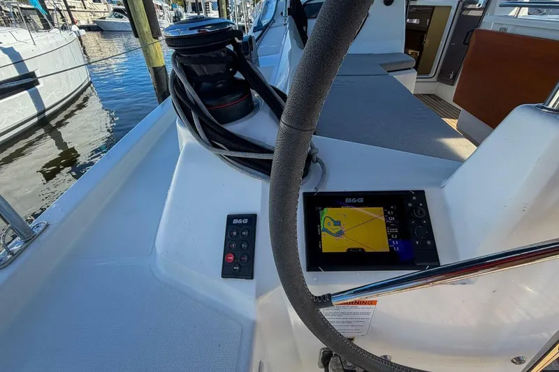 Slide: The Image of 2022 Beneteau Oceanis 40.1 yacht cockpit with steering wheel and navigation equipment. - 55