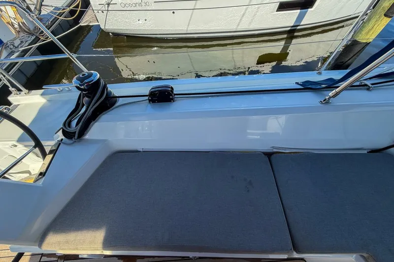 Slide: The Image of 2022 Beneteau Oceanis 40.1 yacht cockpit with teak flooring and control panel. - 75