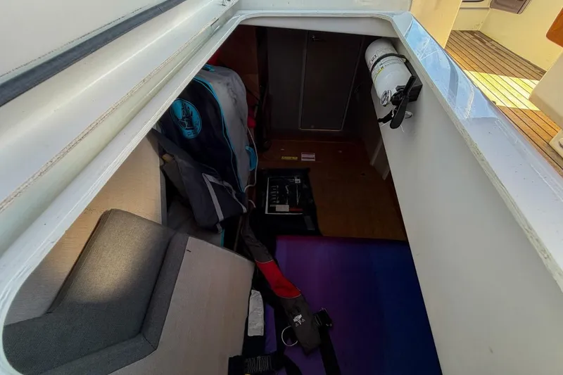 Slide: The Image of 2022 Beneteau Oceanis 40.1 yacht cockpit with open storage compartment and teak flooring. - 78