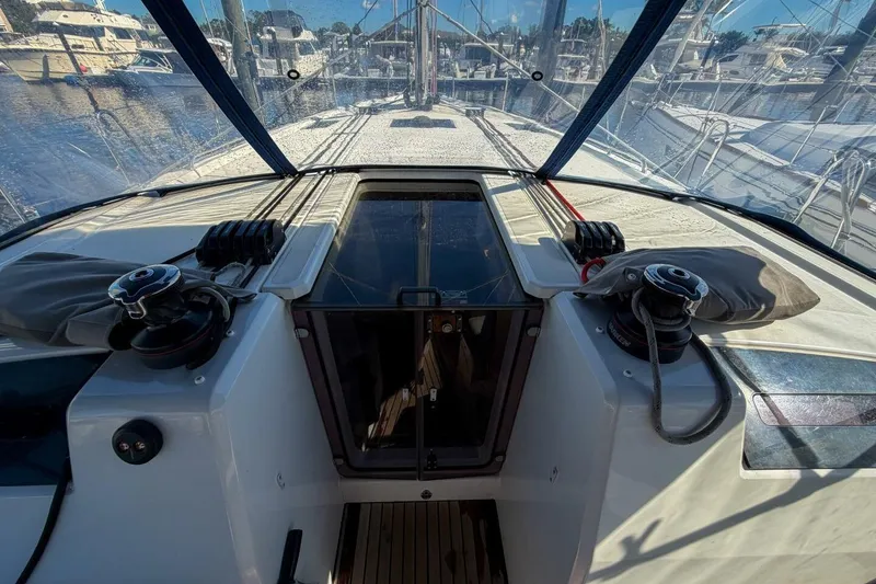 Slide: The Image of 2022 Beneteau Oceanis 40.1 sailboat deck with rigging and marina view. - 82