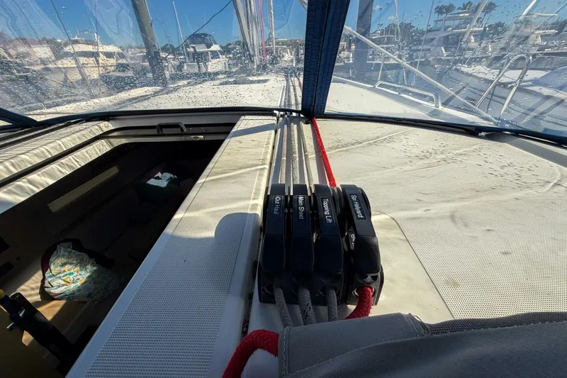Slide: The Image of 2022 Beneteau Oceanis 40.1 yacht cockpit with blue canopy and marina view. - 85