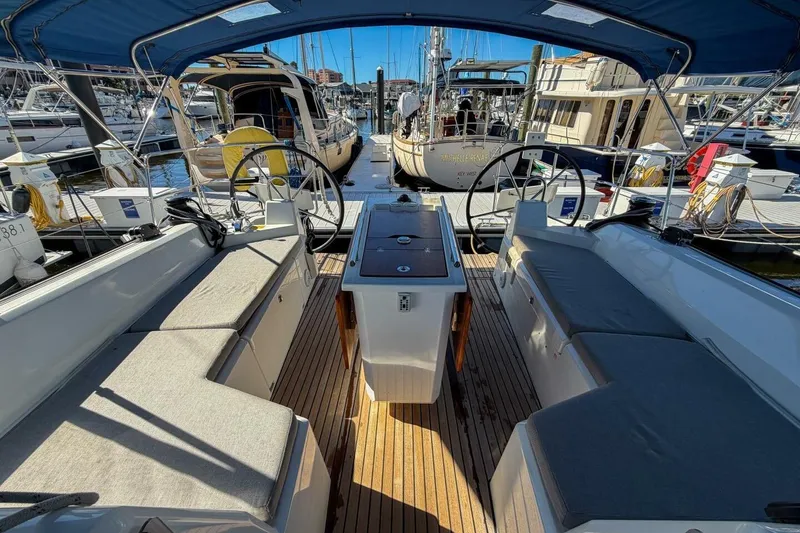 Slide: The Image of 2022 Beneteau Oceanis 40.1 yacht cockpit with cushioned seating and deck features. - 87