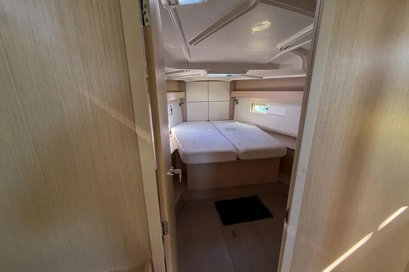 Slide: The Image of 2022 Beneteau Oceanis 40.1 cabin interior with bed and natural light. - 9