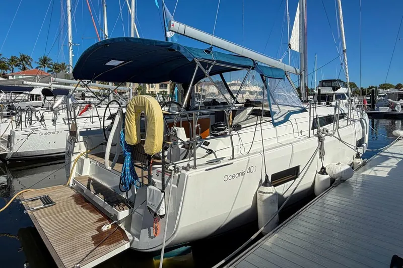 Slide: The Image of 2022 Beneteau Oceanis 40.1 yacht docked at marina, rear view with open deck. - 92
