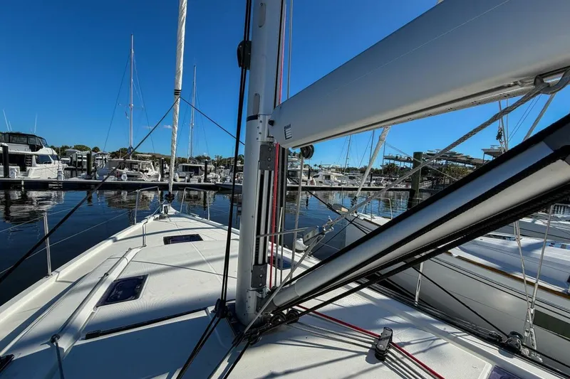 Slide: The Image of 2022 Beneteau Oceanis 40.1 sailboat docked at a marina under clear blue skies. - 96