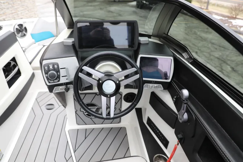 Slide: The Image of 2018 Malibu Wakesetter 23 LSV boat dashboard with modern controls and steering wheel. - 5