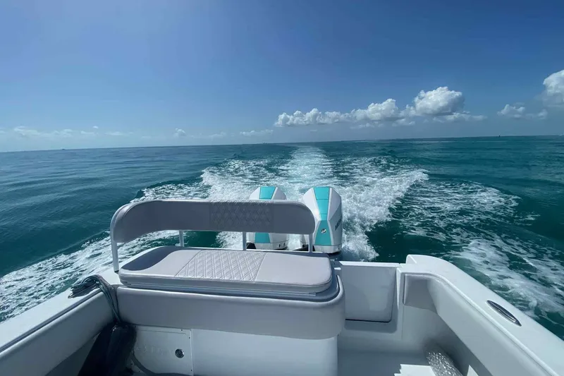 Slide: The Image of 2023 Andros Offshore 32 boat cruising on open sea under clear blue sky. - 12