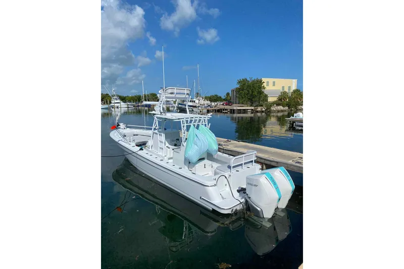 Slide: The Image of 2023 Andros Offshore 32 boat docked in a marina under a clear blue sky. - 14
