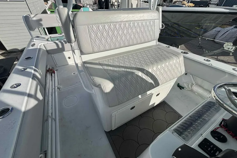 Slide: The Image of 2023 Andros Offshore 32 boat interior with cushioned seating and steering console. - 11