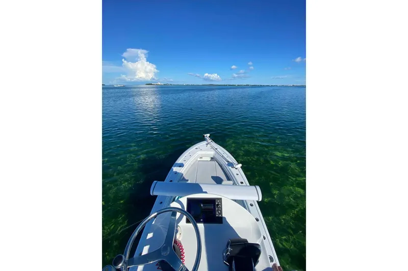 Slide: The Image of 2023 Andros Offshore 32 boat on clear blue water under a sunny sky. - 8