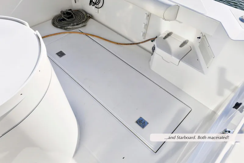 Slide: The Image of Cabo 35 Express 2000 boat deck with storage compartments and coiled rope. - 10