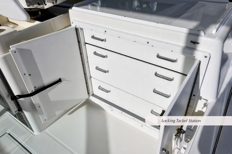 Slide: The Image of Locking tackle station on 2000 Cabo 35 Express boat, featuring multiple storage drawers. - 12
