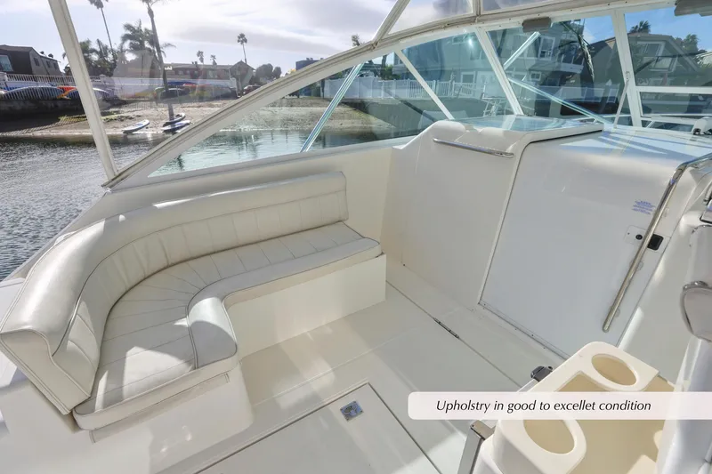Slide: The Image of 2000 Cabo 35 Express boat interior with white seating, excellent upholstery condition. - 2