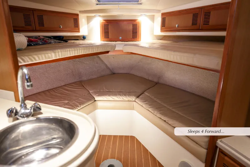 Slide: The Image of 2000 Cabo 35 Express cabin interior with cozy sleeping area and sink. Sleeps four. - 20