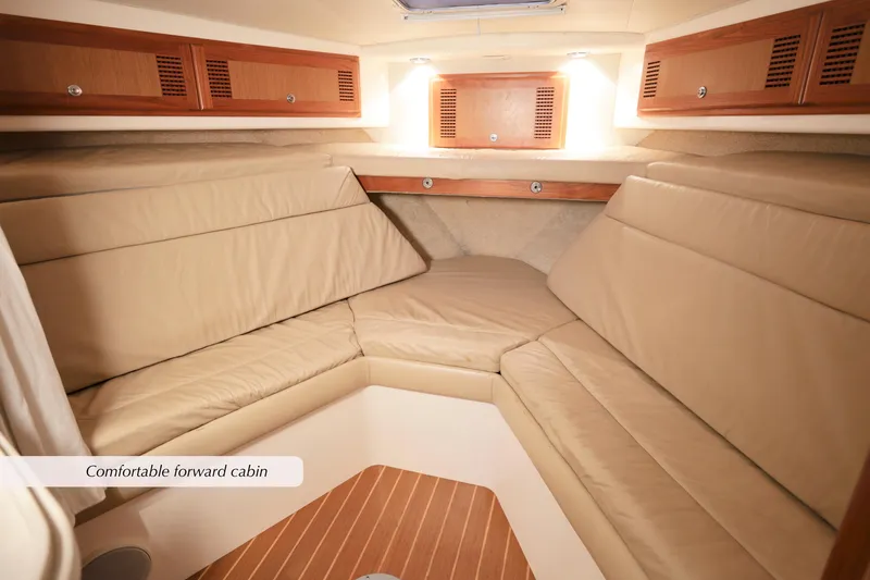 Slide: The Image of Forward cabin of 2000 Cabo 35 Express with beige seating and wooden accents. - 21