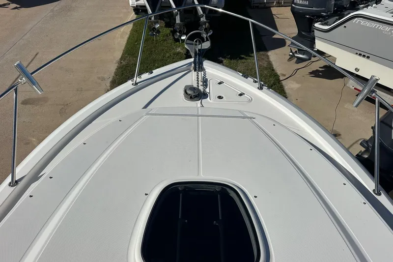 Slide: The Image of 2012 Boston Whaler 315 Conquest boat deck with railing and hatch. - 10