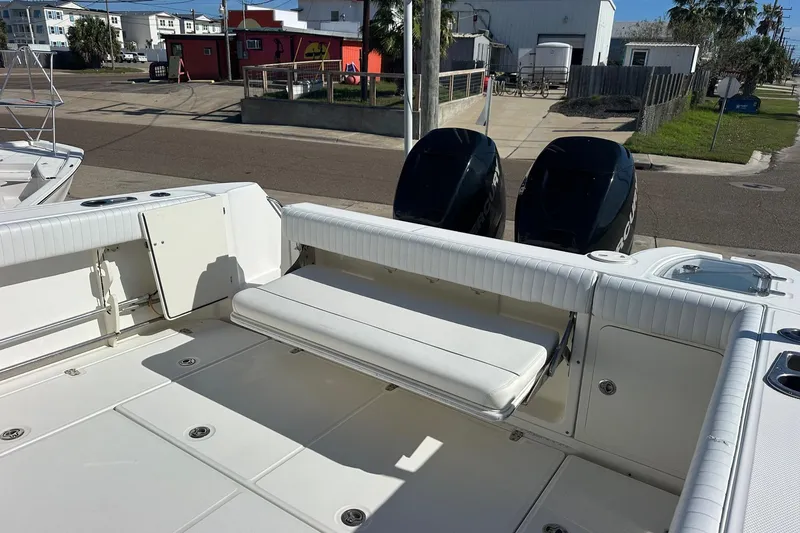 Slide: The Image of 2012 Boston Whaler 315 Conquest boat deck with seating and dual outboard engines. - 8