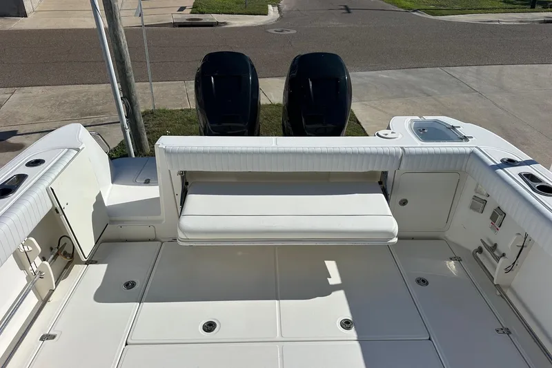 Slide: The Image of 2012 Boston Whaler 315 Conquest boat deck with seating and dual engines. - 9