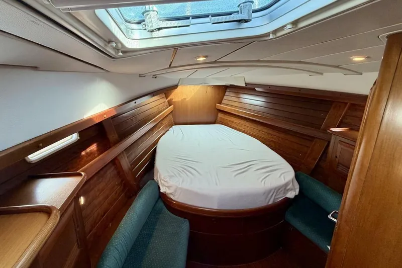 Slide: The Image of Luxurious cabin interior of 2000 Beneteau Oceanis 461 sailboat with wood paneling and skylight. - 18