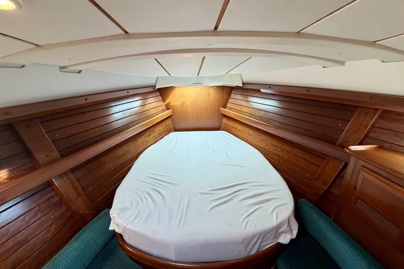 Slide: The Image of Cozy cabin interior of 2000 Beneteau Oceanis 461 sailboat with wooden paneling and bed. - 20