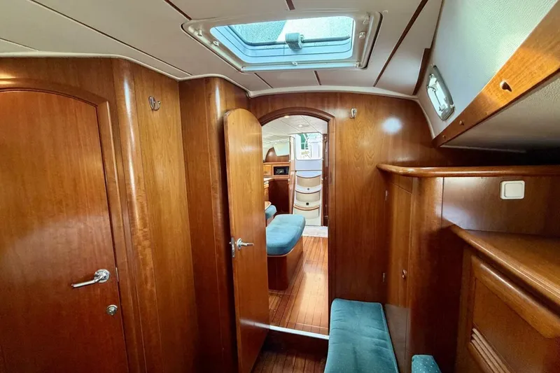 Slide: The Image of Interior of 2000 Beneteau Oceanis 461 yacht with wooden finish and seating area. - 23