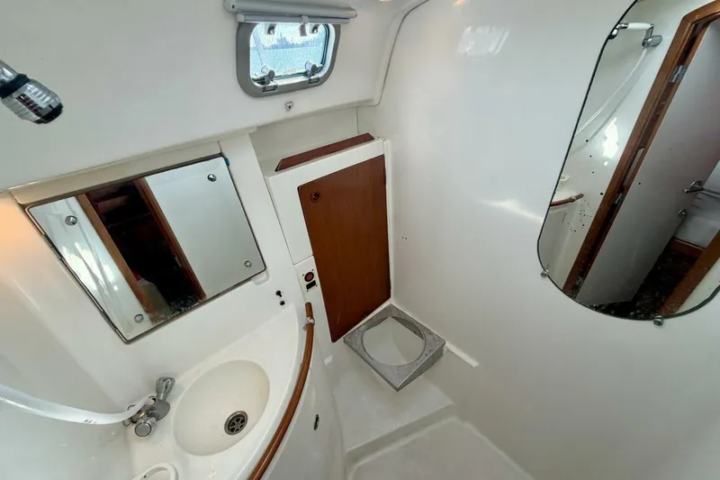 Slide: The Image of Bathroom interior of 2000 Beneteau Oceanis 461 yacht, featuring sink and mirrors. - 24