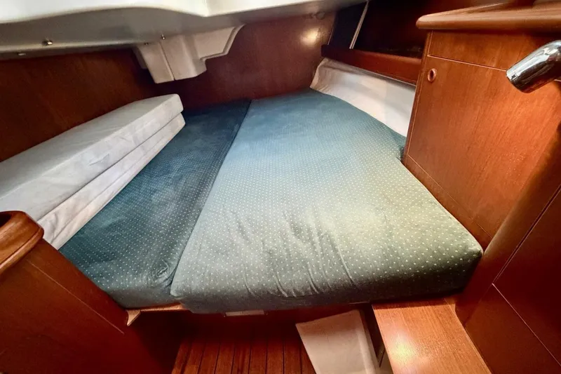 Slide: The Image of Cozy cabin interior of 2000 Beneteau Oceanis 461 sailboat with wooden finish and comfortable bedding. - 28