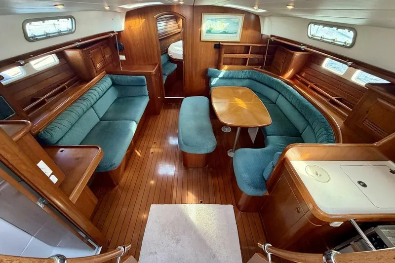 Slide: The Image of Interior of 2000 Beneteau Oceanis 461 yacht with wood finish and blue seating. - 3