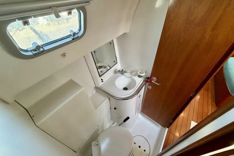 Slide: The Image of Beneteau Oceanis 461 yacht bathroom with sink, toilet, and porthole window, 2000 model. - 33