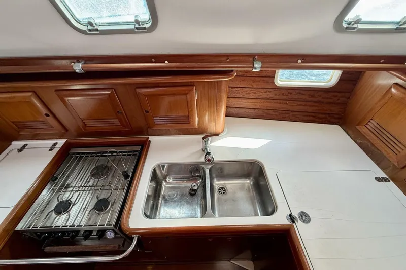 Slide: The Image of Beneteau Oceanis 461 yacht kitchen with stove, sink, and wooden cabinets, 2000 model. - 37