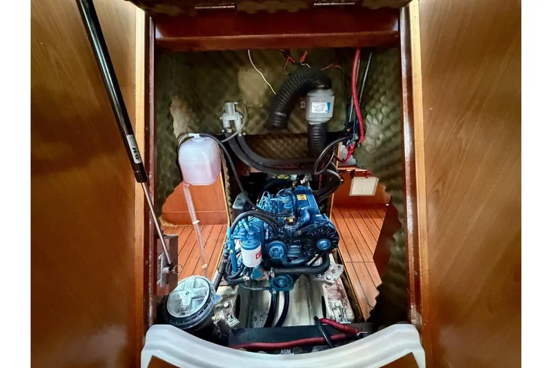 Slide: The Image of Engine compartment of a 2000 Beneteau Oceanis 461 sailboat, showcasing detailed mechanical components. - 42