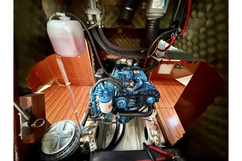 Slide: The Image of Engine room of 2000 Beneteau Oceanis 461 sailboat, showcasing detailed mechanical components. - 43
