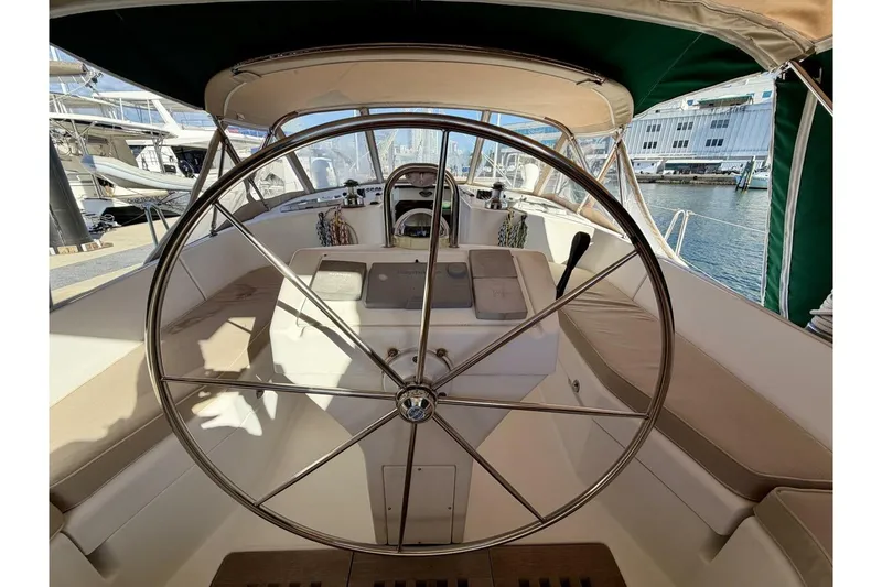 Slide: The Image of Steering wheel of 2000 Beneteau Oceanis 461 sailboat in marina setting. - 49