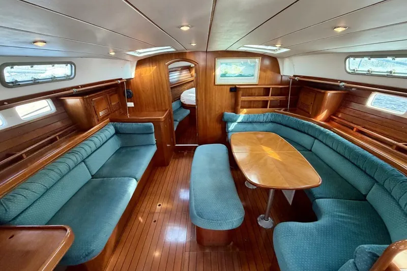 Slide: The Image of Interior of 2000 Beneteau Oceanis 461 yacht with elegant wood finish and cozy seating. - 5
