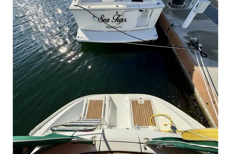 Slide: The Image of Beneteau Oceanis 461 sailboat docked near another boat, sunny marina view. - 59