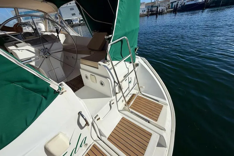 Slide: The Image of Beneteau Oceanis 461 sailboat cockpit with green canopy, docked at marina, 2000 model. - 60
