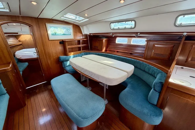 Slide: The Image of Interior of 2000 Beneteau Oceanis 461 yacht with elegant wood finish and cozy seating. - 7