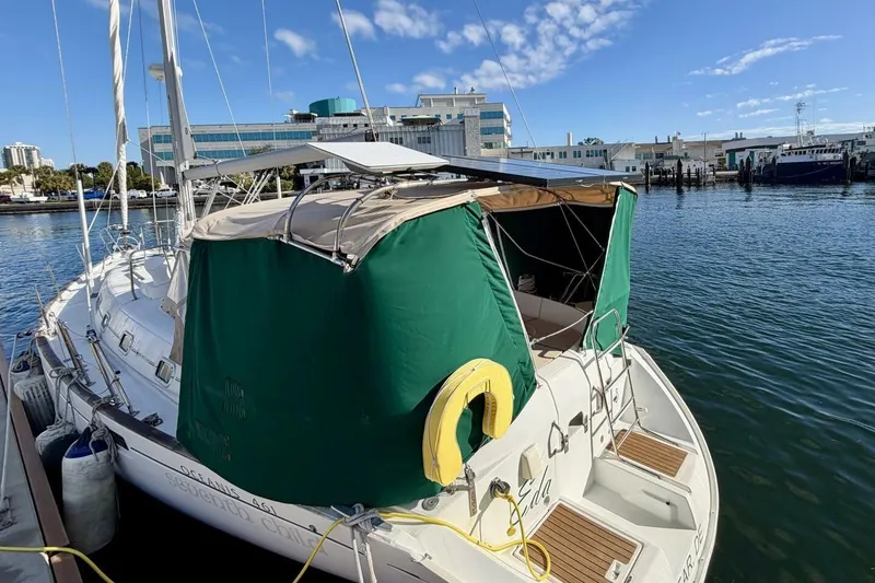 Slide: The Image of Beneteau Oceanis 461 sailboat docked at marina, 2000 model, with green canopy. - 78