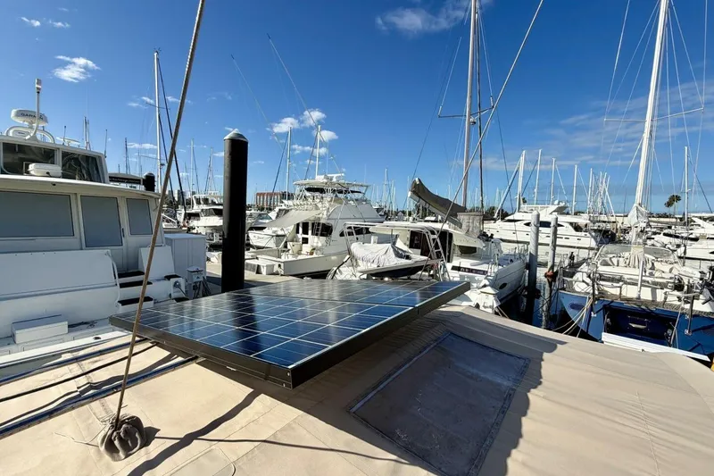 Slide: The Image of Beneteau Oceanis 461 sailboat with solar panels docked in a marina, 2000 model. - 79