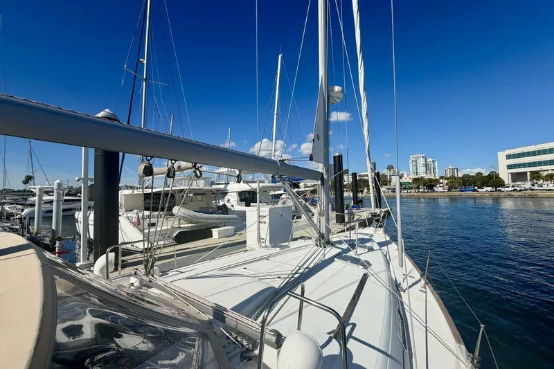 Slide: The Image of 2000 Beneteau Oceanis 461 sailboat docked at marina with city skyline. - 82