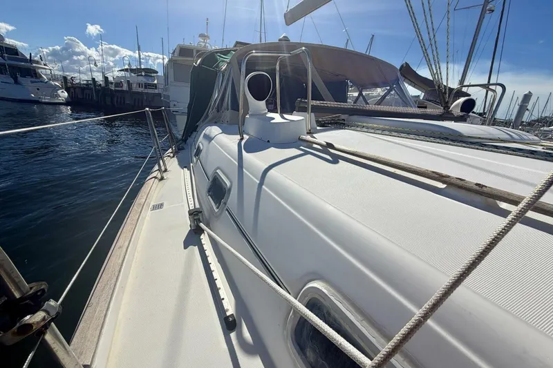 Slide: The Image of 2000 Beneteau Oceanis 461 sailboat docked at marina under clear blue sky. - 84