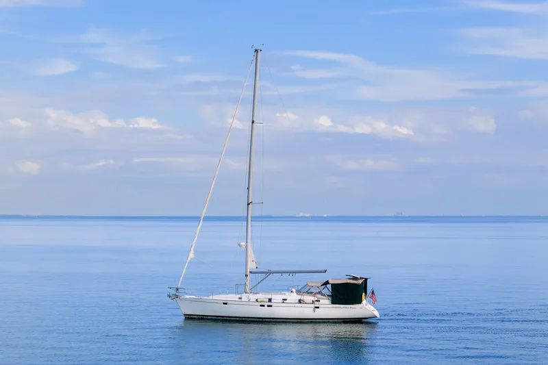 Slide: The Image of Sailboat Beneteau Oceanis 461, 2000 model, cruising on calm blue waters under a clear sky. - 87