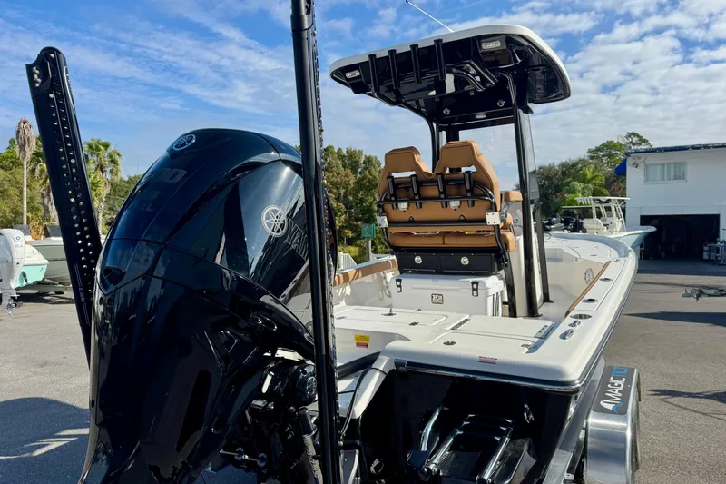 Slide: The Image of 2026 Key West 230 Bay Reef boat with Yamaha engine, parked outdoors under a blue sky. - 10